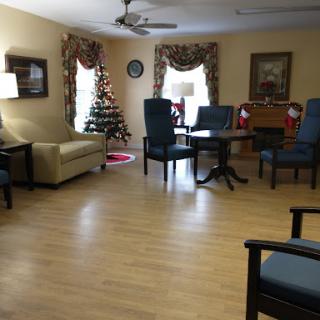 A cozy living room featuring festive holiday decorations and comfortable seating.