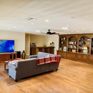 Spacious living room with a comfortable sofa, large television, and built-in bookshelves.