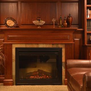 A cozy living room with a wooden fireplace and elegant decor.