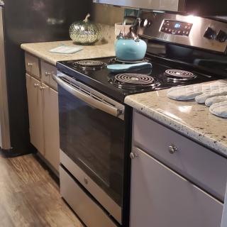 A modern kitchen featuring a sleek stove and countertop setup.