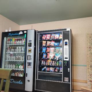 A vending area featuring machines stocked with various snacks and drinks.