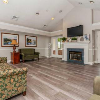 A cozy living room with a fireplace, television, and comfortable seating.