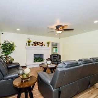 A cozy living room featuring a fireplace, comfortable seating, and decorative elements.