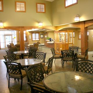 A cozy and inviting caf interior featuring comfortable seating and warm lighting.