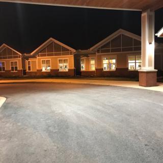 A well-lit building captured at night with visible architectural details.