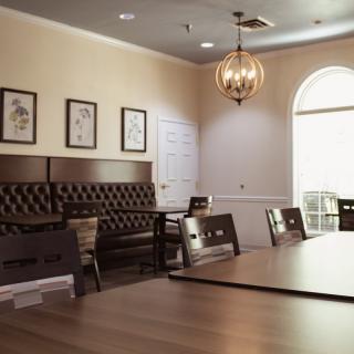 A cozy dining area with elegant seating and warm lighting.