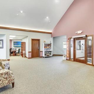 A spacious lobby area with seating and a reception desk.