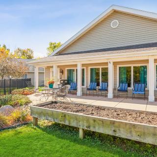 A beautiful house with a landscaped garden and a spacious patio area.