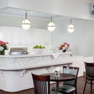 A modern restaurant dining area featuring elegant lighting and floral accents.