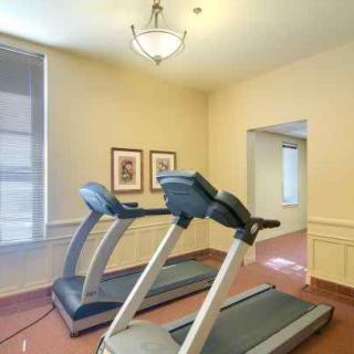 A small indoor gym with two treadmills positioned side by side.