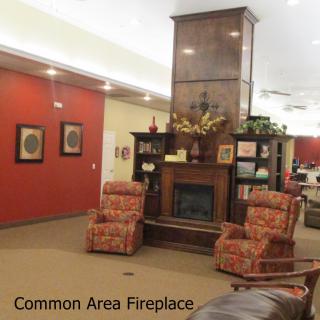 A cozy common area featuring a fireplace and comfortable seating.