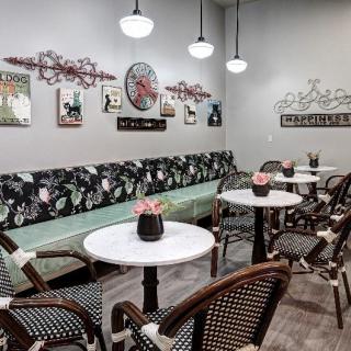 A cozy cafe interior with stylish seating and decorative artwork on the walls.