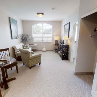 A cozy living room with comfortable seating and a large window.