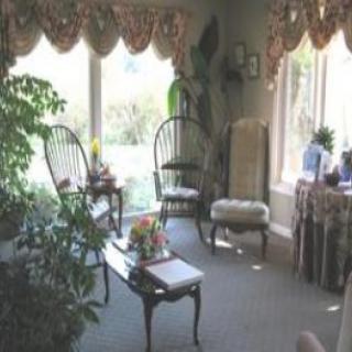 A cozy living room with elegant furniture, large windows, and abundant natural light.