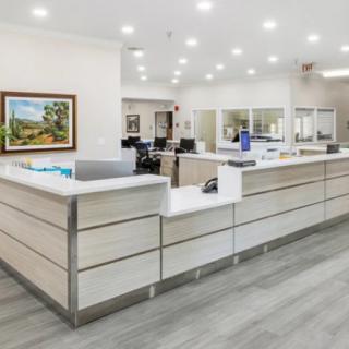 A modern hospital reception area with a spacious desk and bright lighting.