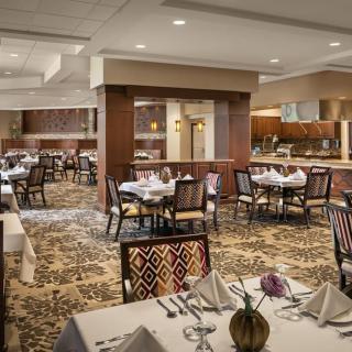 An elegantly decorated restaurant dining room with neatly arranged tables and chairs.