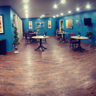 A modern restaurant interior with blue walls, stylish decor, and a warm ambiance.