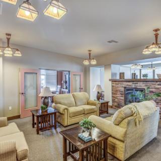 A cozy living room with comfortable sofas, a fireplace, and warm lighting.