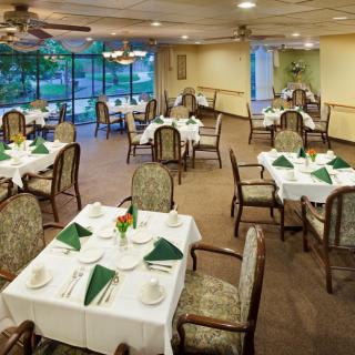 An elegant dining room with neatly arranged tables and chairs, ready for guests.
