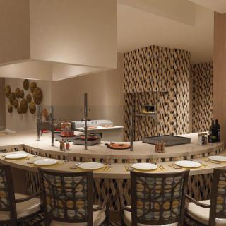 A modern restaurant interior featuring counter seating with warm lighting and decorative elements.
