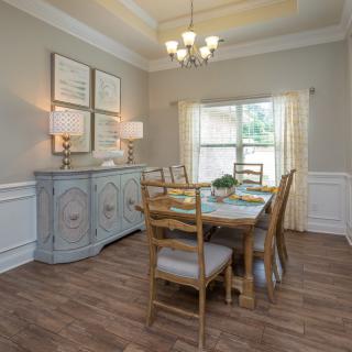 A cozy dining room with elegant decor and natural lighting.