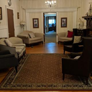 A cozy living room with elegant furnishings and a chandelier.