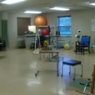 A physical therapy room equipped with exercise equipment for rehabilitation.