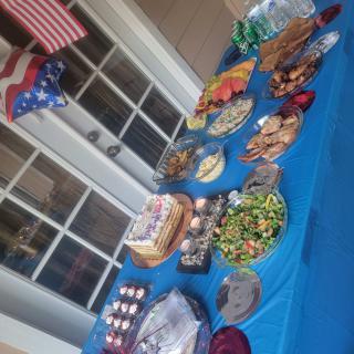 A festive table setup with a variety of foods and patriotic decorations.