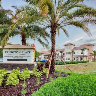 A modern apartment complex named 'Lexington Place' surrounded by well-maintained landscaping and palm trees.