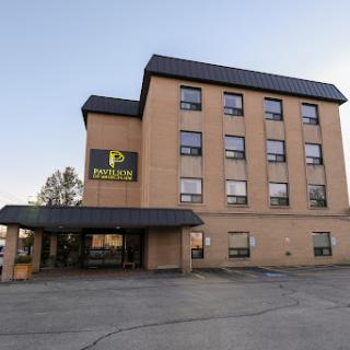 A view of a modern hotel building featuring multiple floors and a welcoming entrance.