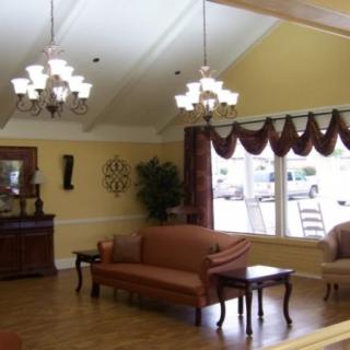 Elegant living room with chandeliers and classic furniture.