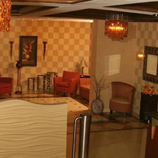 A well-decorated lobby area featuring elegant chandeliers, comfortable seating, and stylish wall art.