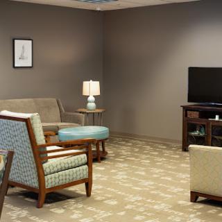 A cozy living room setup featuring comfortable seating and a warm ambiance.