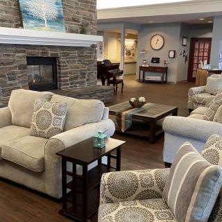A cozy living room with plush seating and a fireplace.