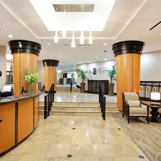 A modern hotel lobby with a reception desk and stylish interior design.