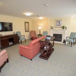 A cozy living room with a fireplace, comfortable seating, and a television.