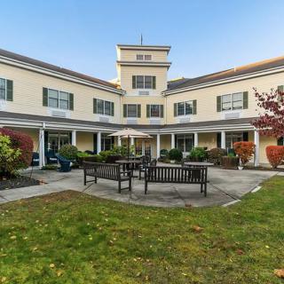 A well-maintained building with a garden and outdoor seating area.