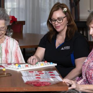 A group of women enjoying a game of bingo together in a community setting.