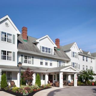 A large, elegant residential building with a well-maintained exterior and landscaped surroundings.