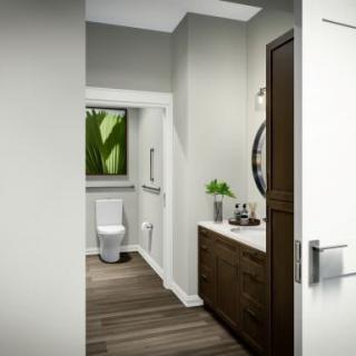 A modern bathroom with a sleek design, featuring wooden cabinets, a round mirror, and minimalist decor.