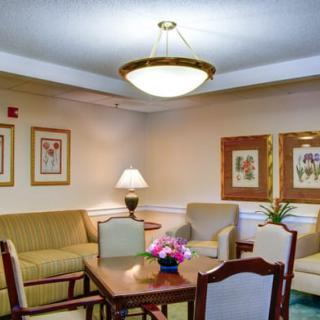 A cozy living room with comfortable seating, a table, and elegant decor.