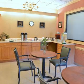 A cozy cafe interior featuring tables and chairs, ideal for relaxation and socializing.
