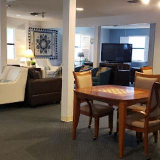 A cozy living room with comfortable seating and a dining table.