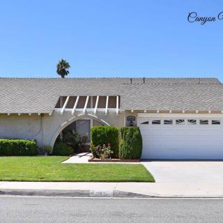 A suburban house with a neatly maintained front yard and attached garage.