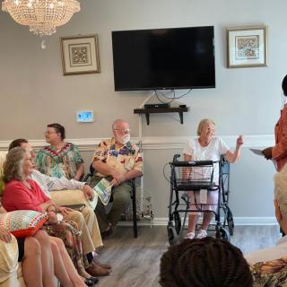 A group of people gathered indoors, engaging in conversation.