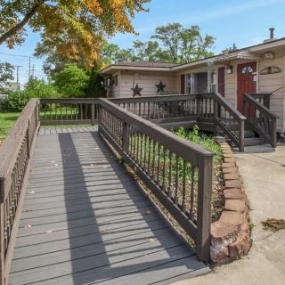 A suburban house with a wooden ramp leading to the entrance.
