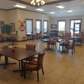 A spacious dining area with tables and chairs arranged for social gatherings.