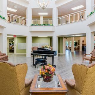 A well-furnished lobby featuring a grand piano and elegant seating area.