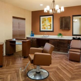 A modern and stylish hair salon interior with comfortable chairs and mirrors.