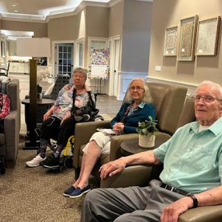A group of seniors enjoying time together in a cozy seating area.